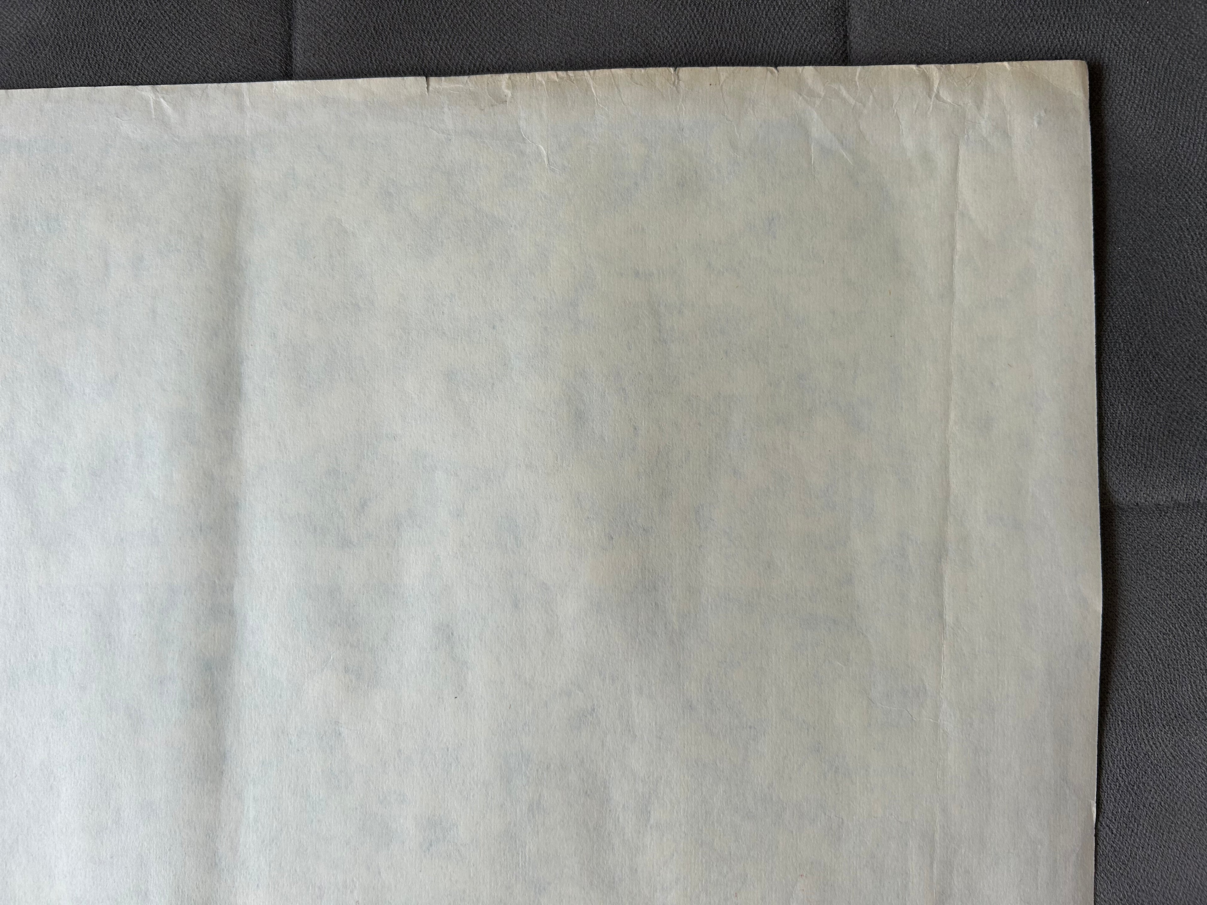 Close-up of a textured beige fabric on a dark background