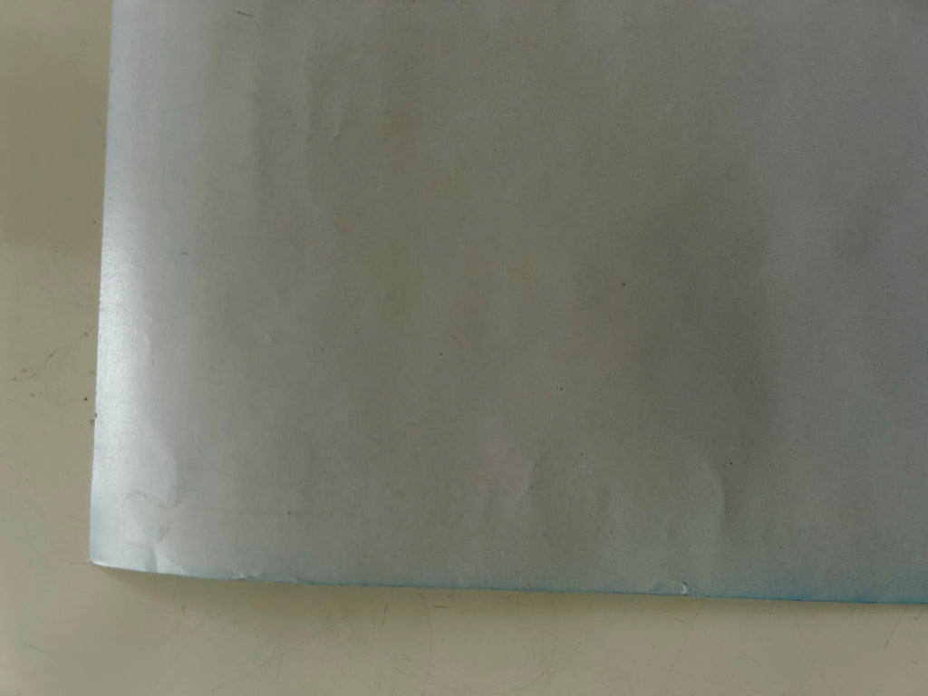 Sheet of white paper on a beige surface