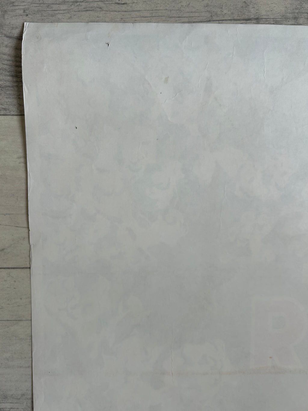 Sheet of white paper on a wooden surface
