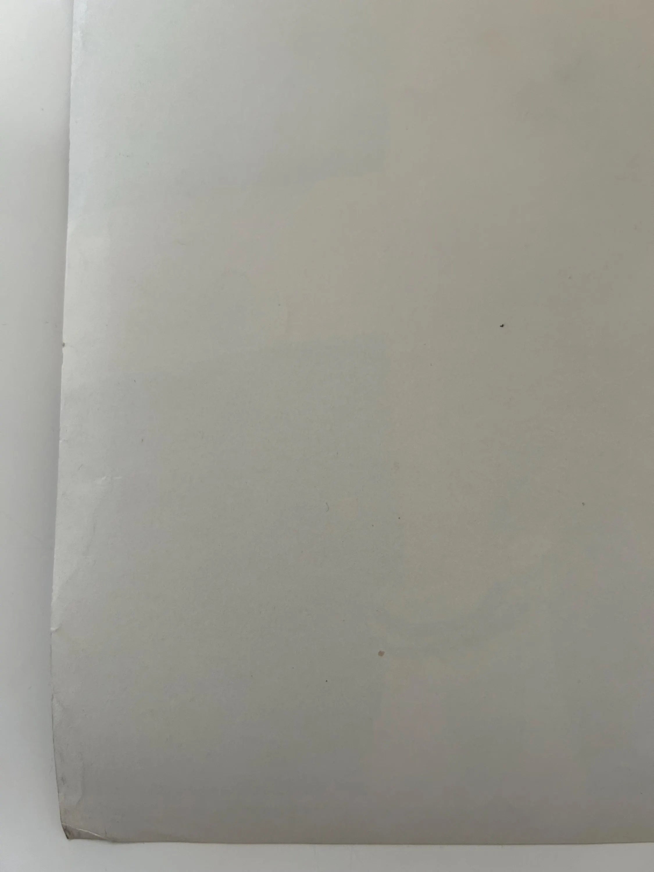 Plain white sheet of paper on a white background