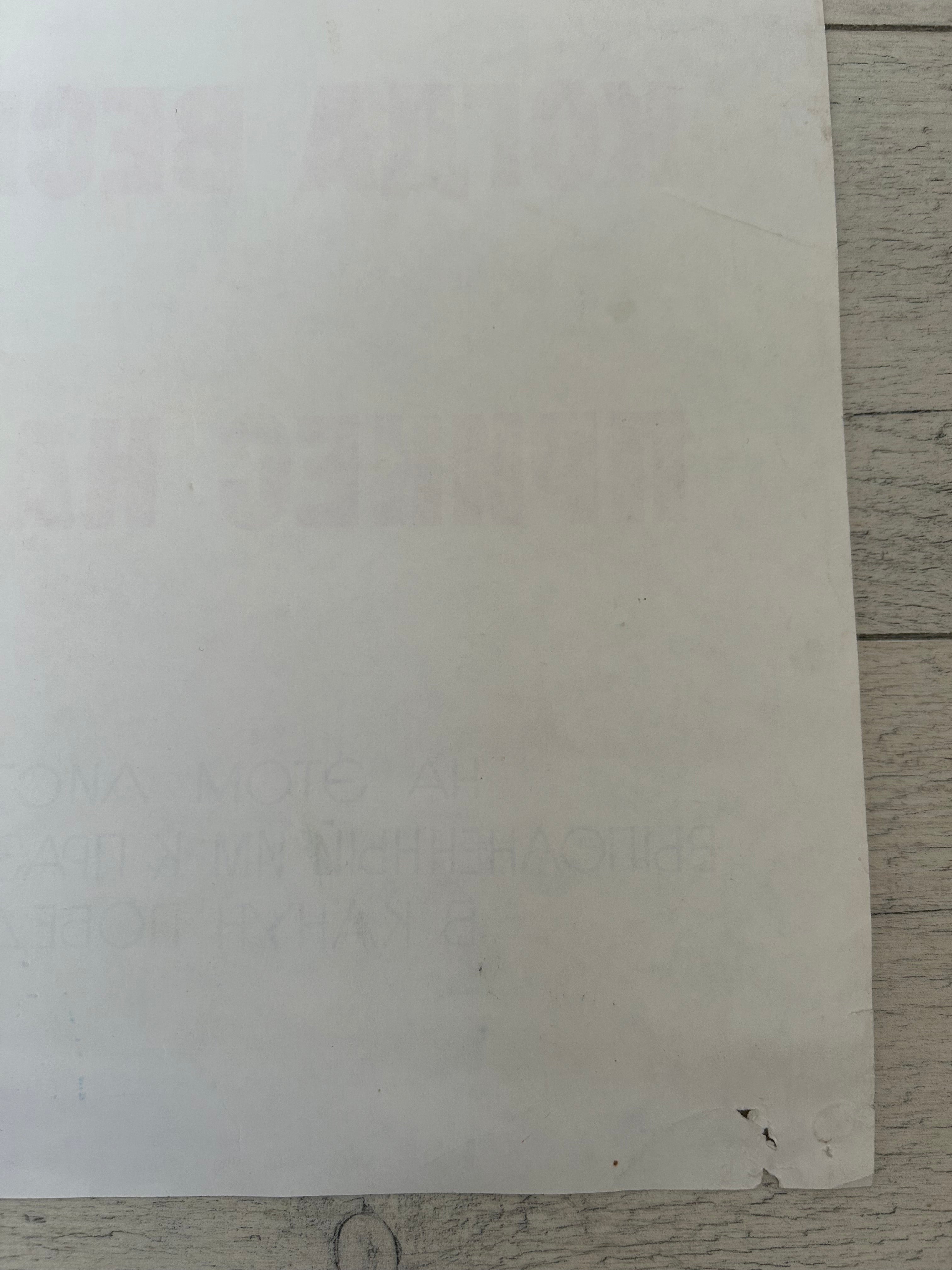 White sheet of paper on a wooden surface