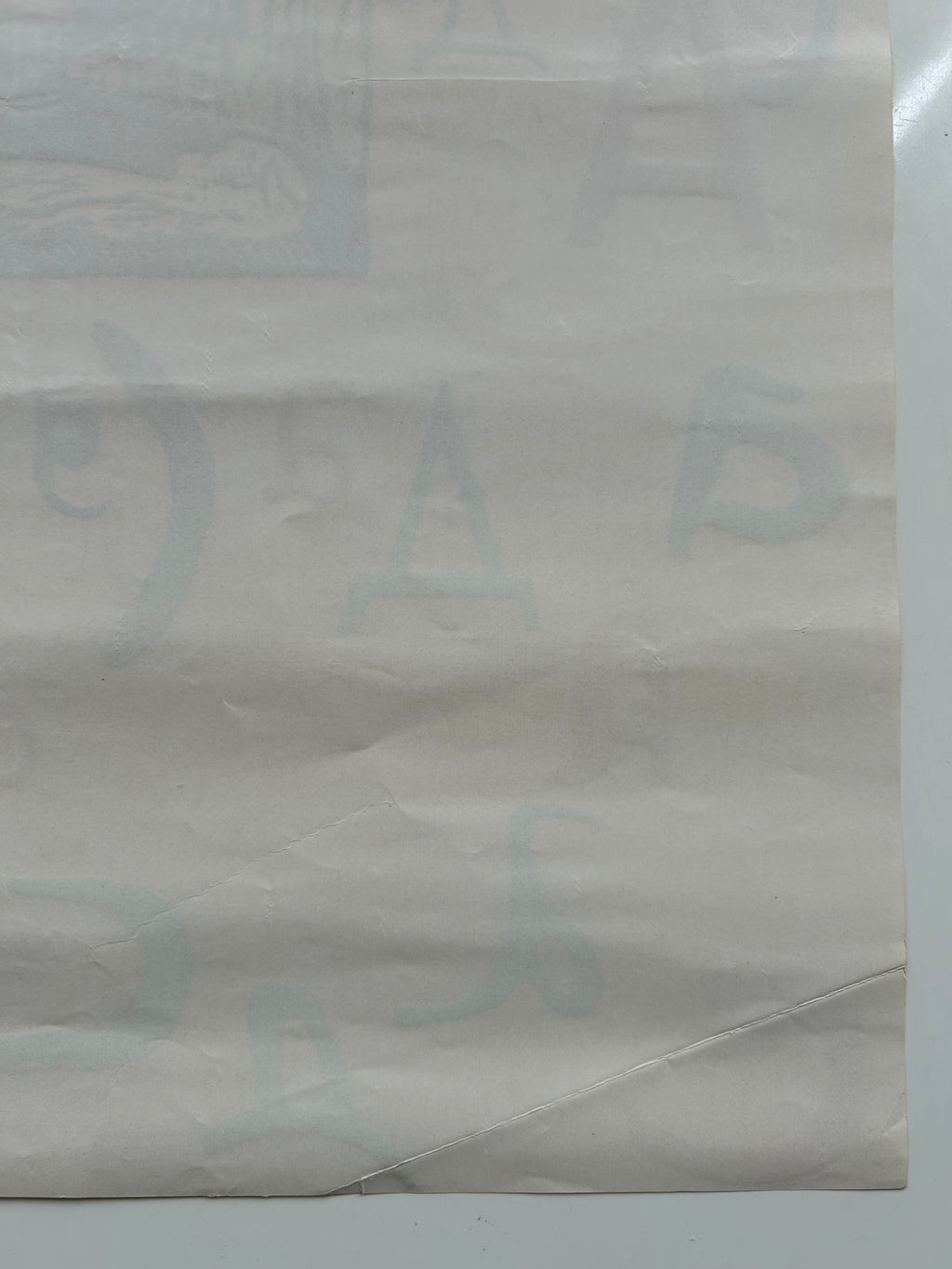 Close-up of a textured beige paper with a brand logo.