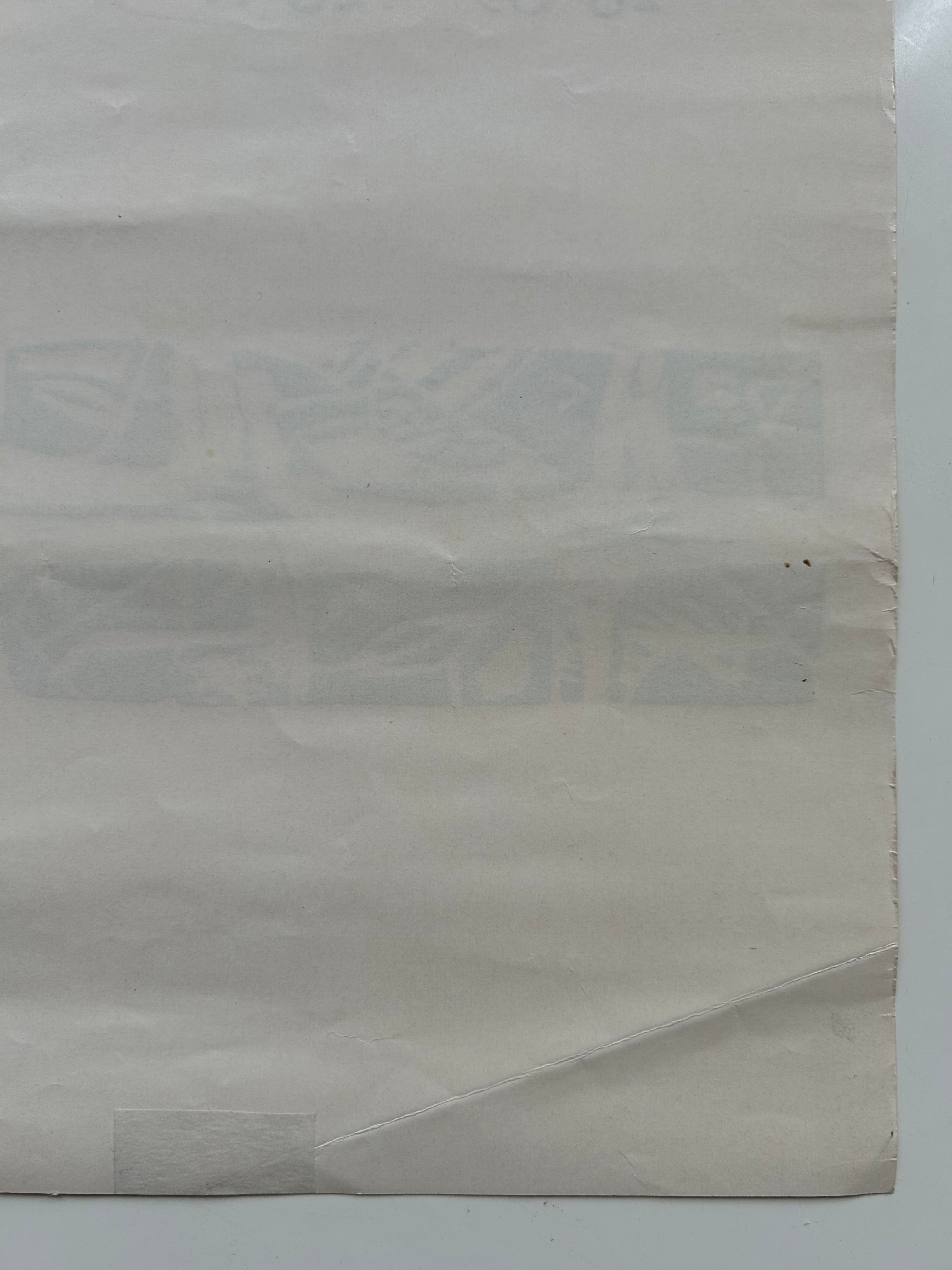 Close-up of a textured beige paper with visible folds on a white background