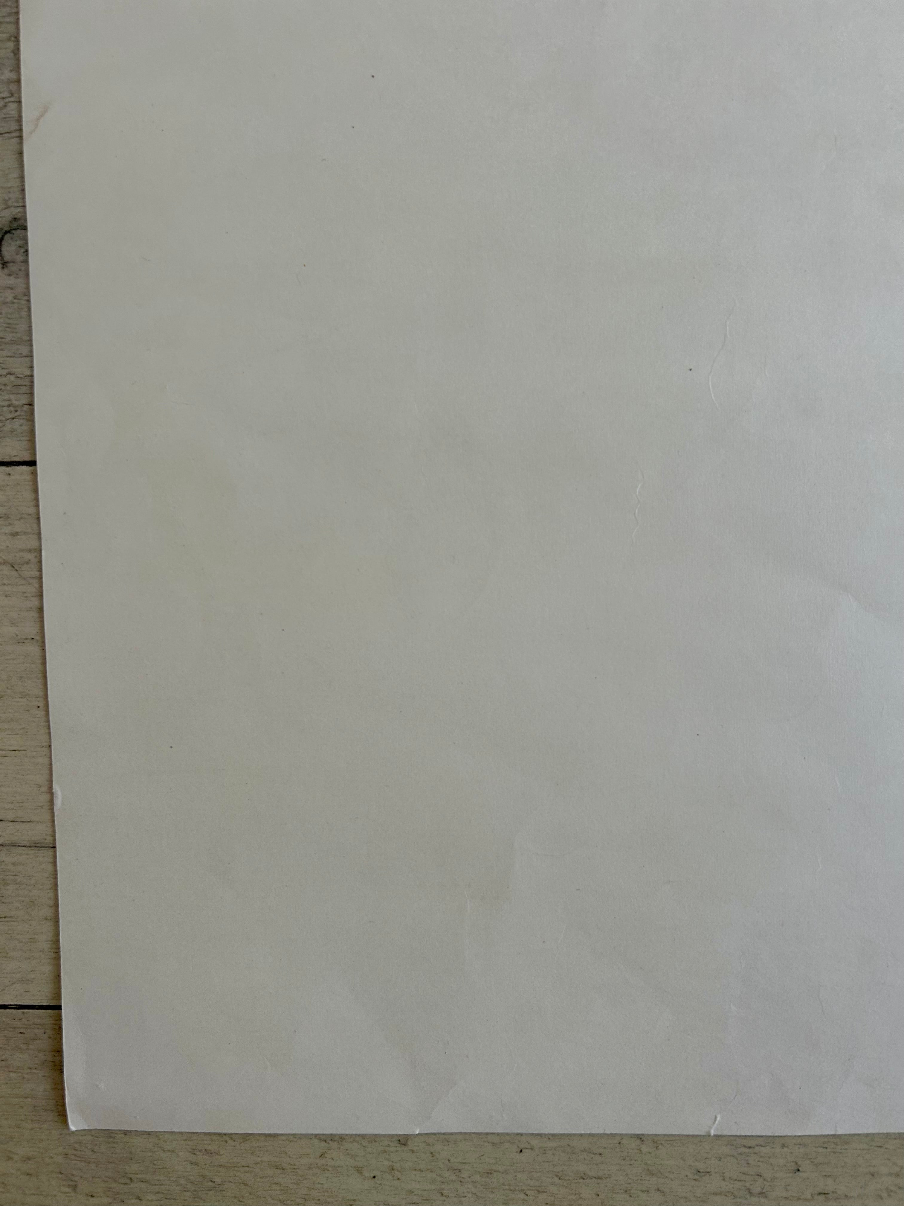 Plain white sheet of paper on a wooden surface