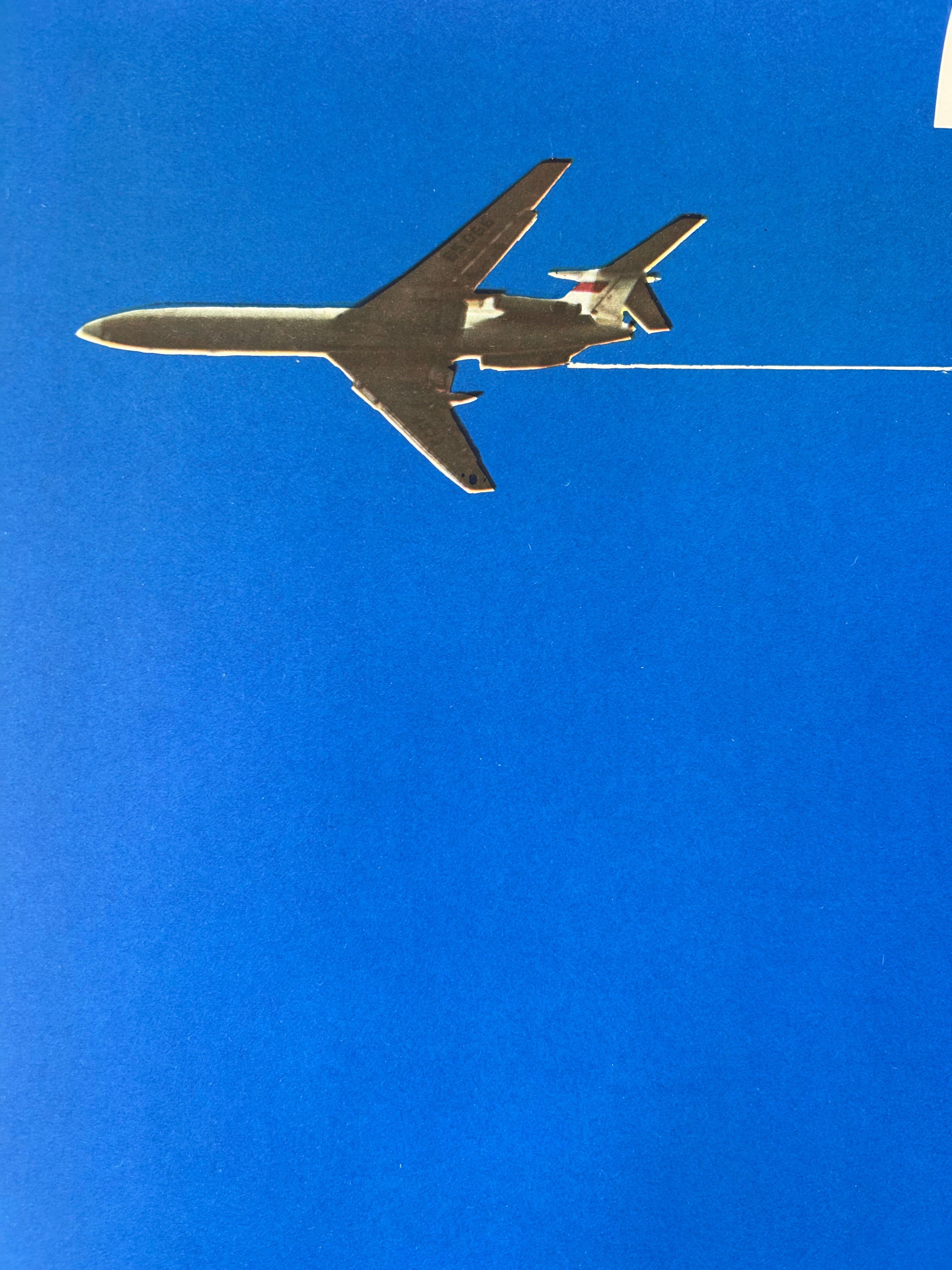 Metallic airplane model against a clear blue sky