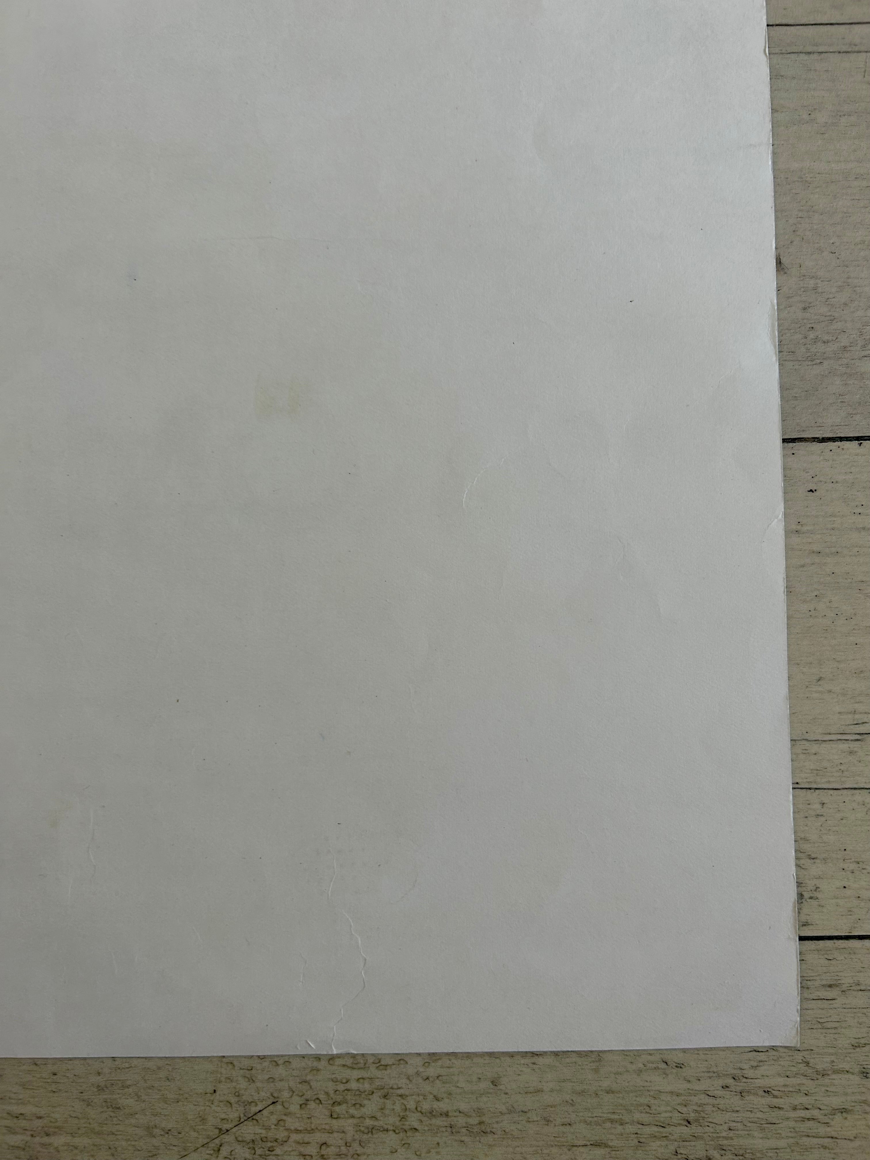 White sheet of paper on a wooden surface