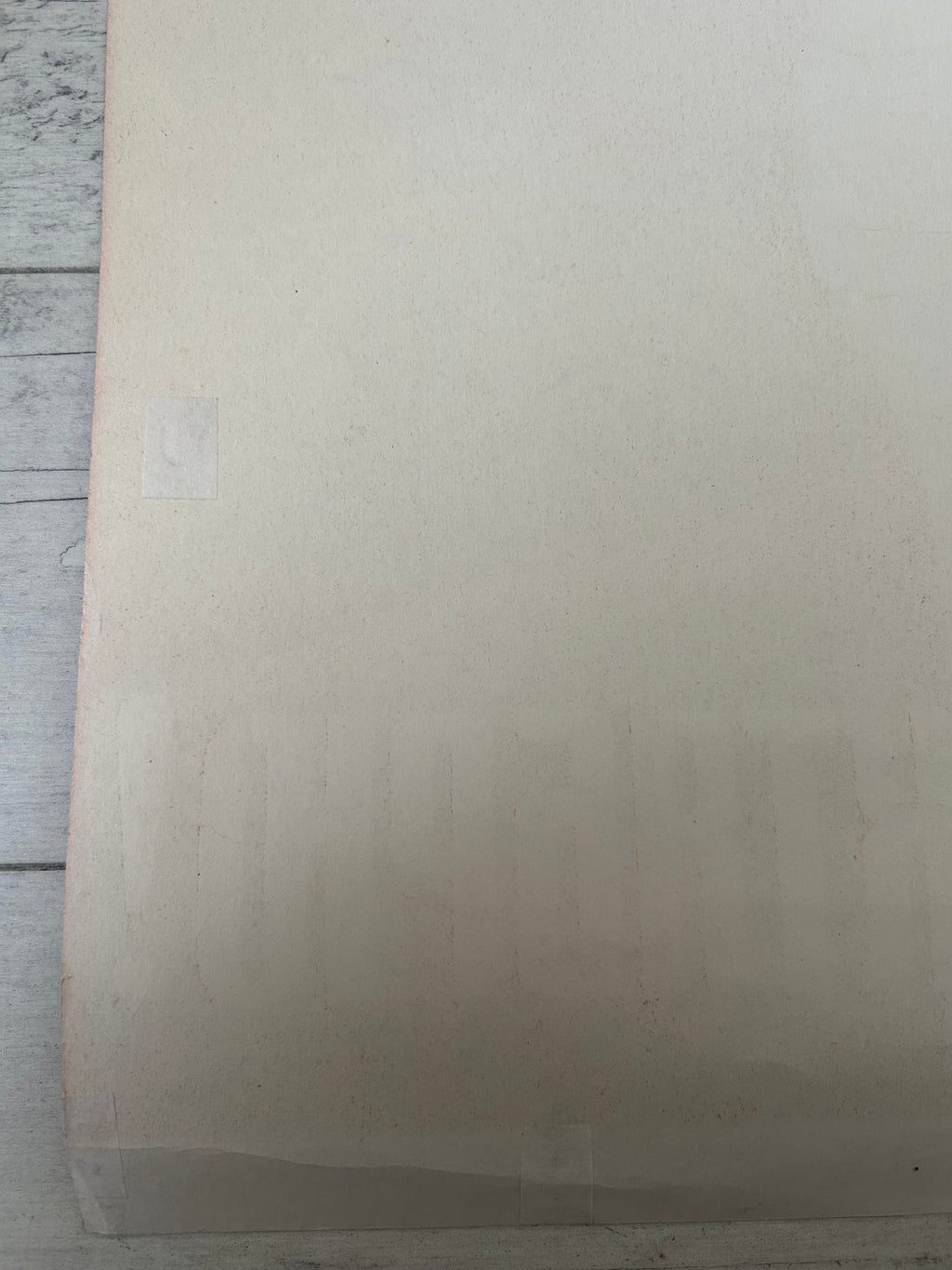 Beige textured paper on a wooden surface