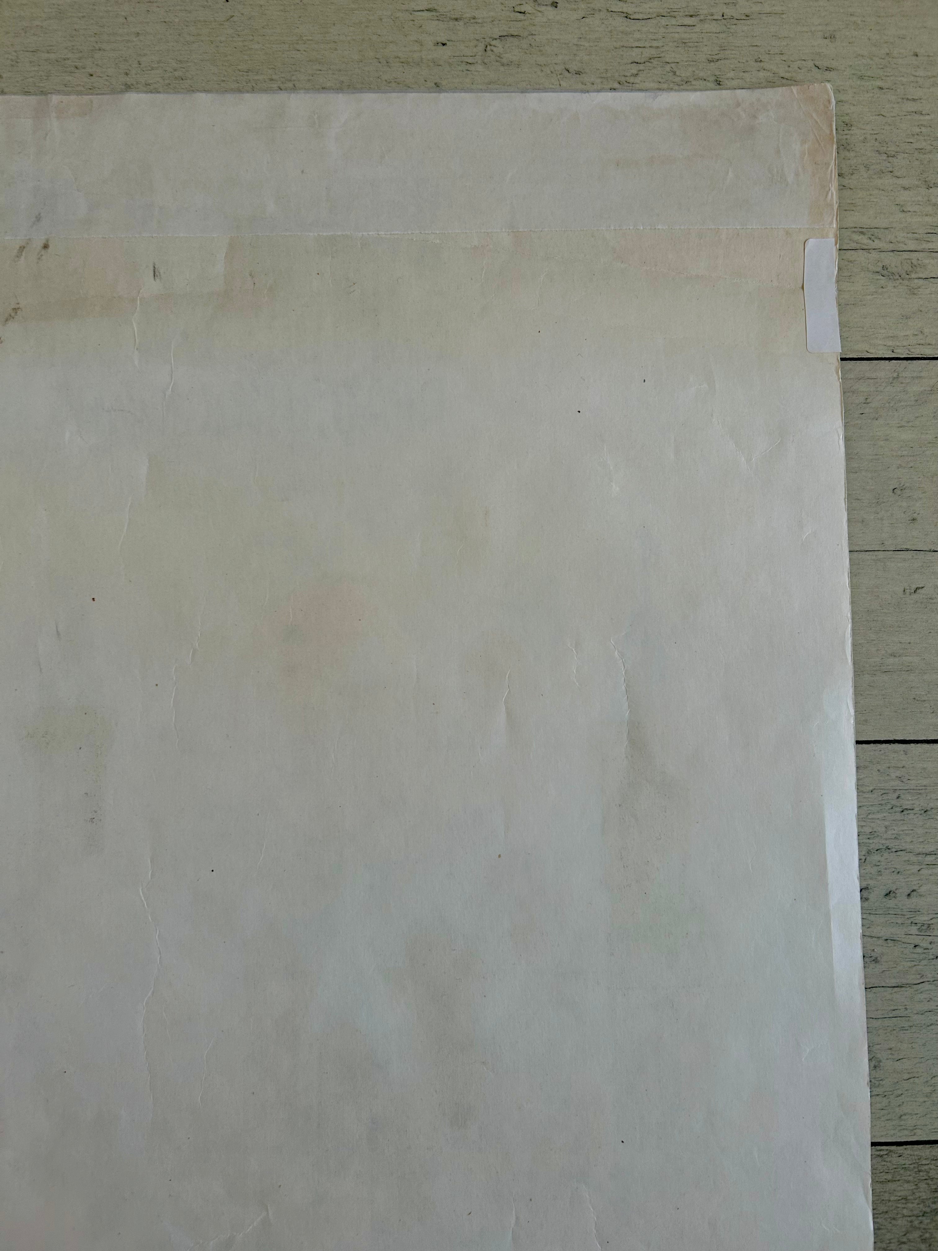 Sheet of plain white paper on a wooden surface