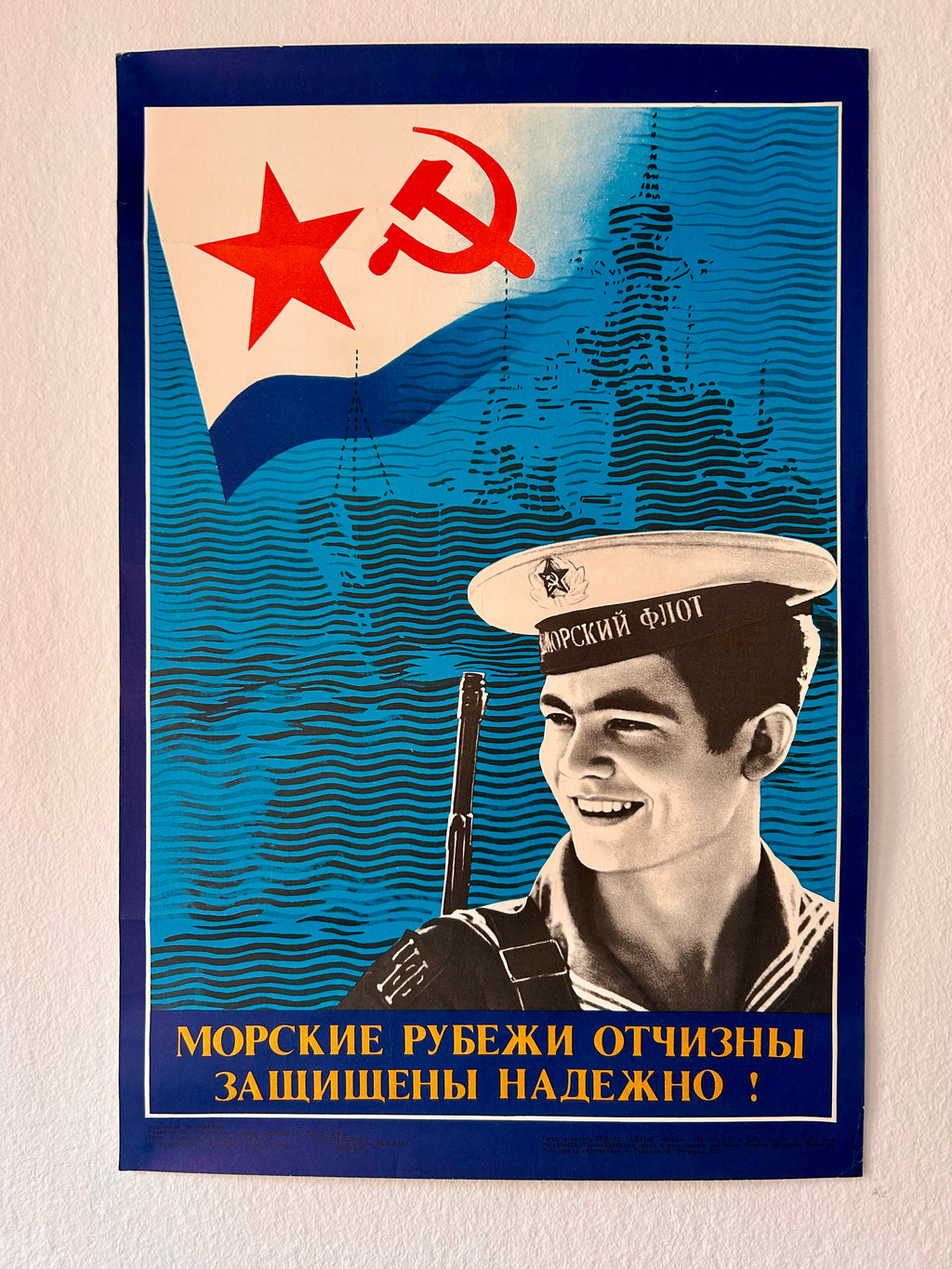 Soviet-style poster with a sailor and a flag featuring a star and hammer-sickle.
