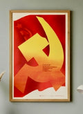 Framed poster with a yellow hammer and sickle symbol on a red background, featuring 'CCCP' text.