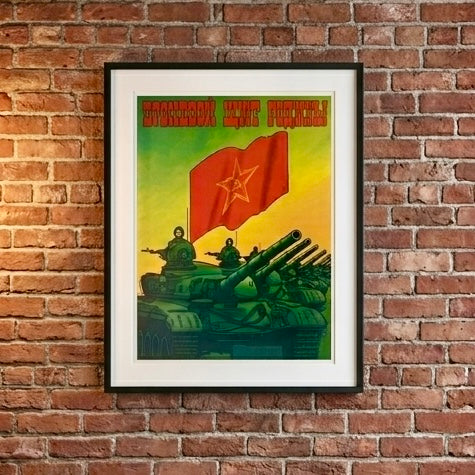 Framed vintage-style poster with tanks and a red flag on a brick wall.