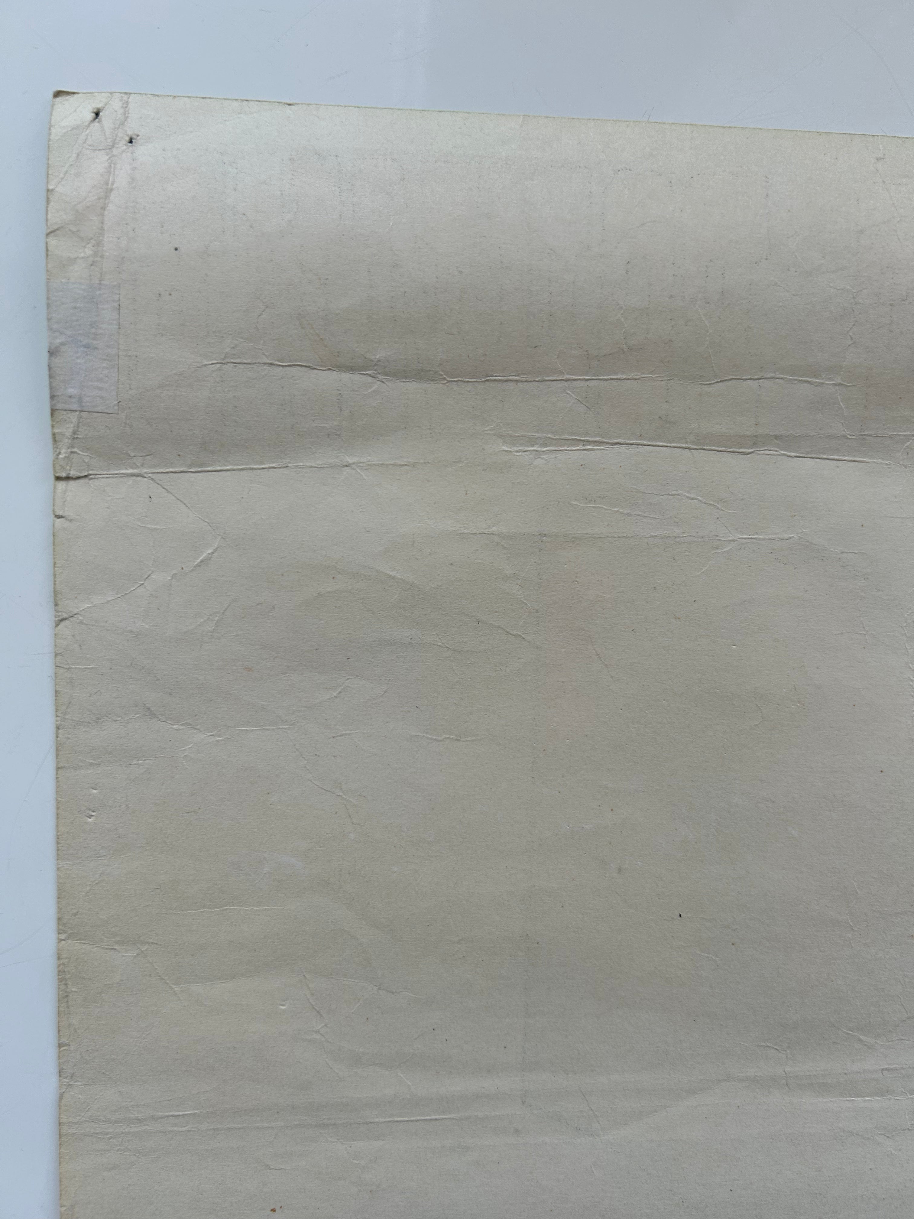 Beige textured paper on a light gray background