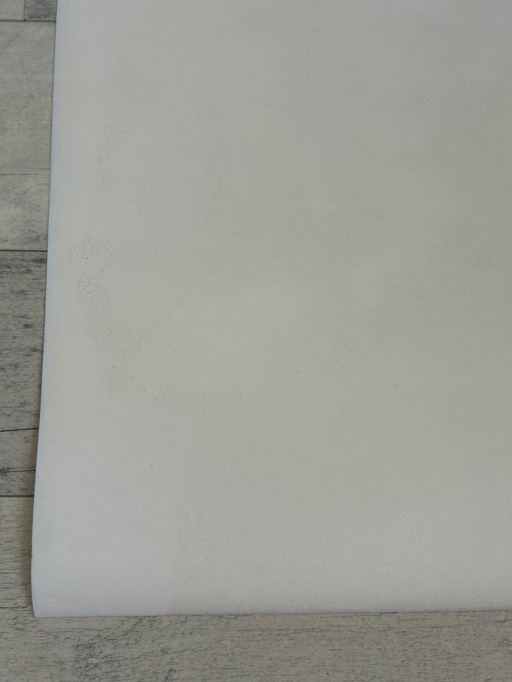 White sheet of paper on a wooden surface