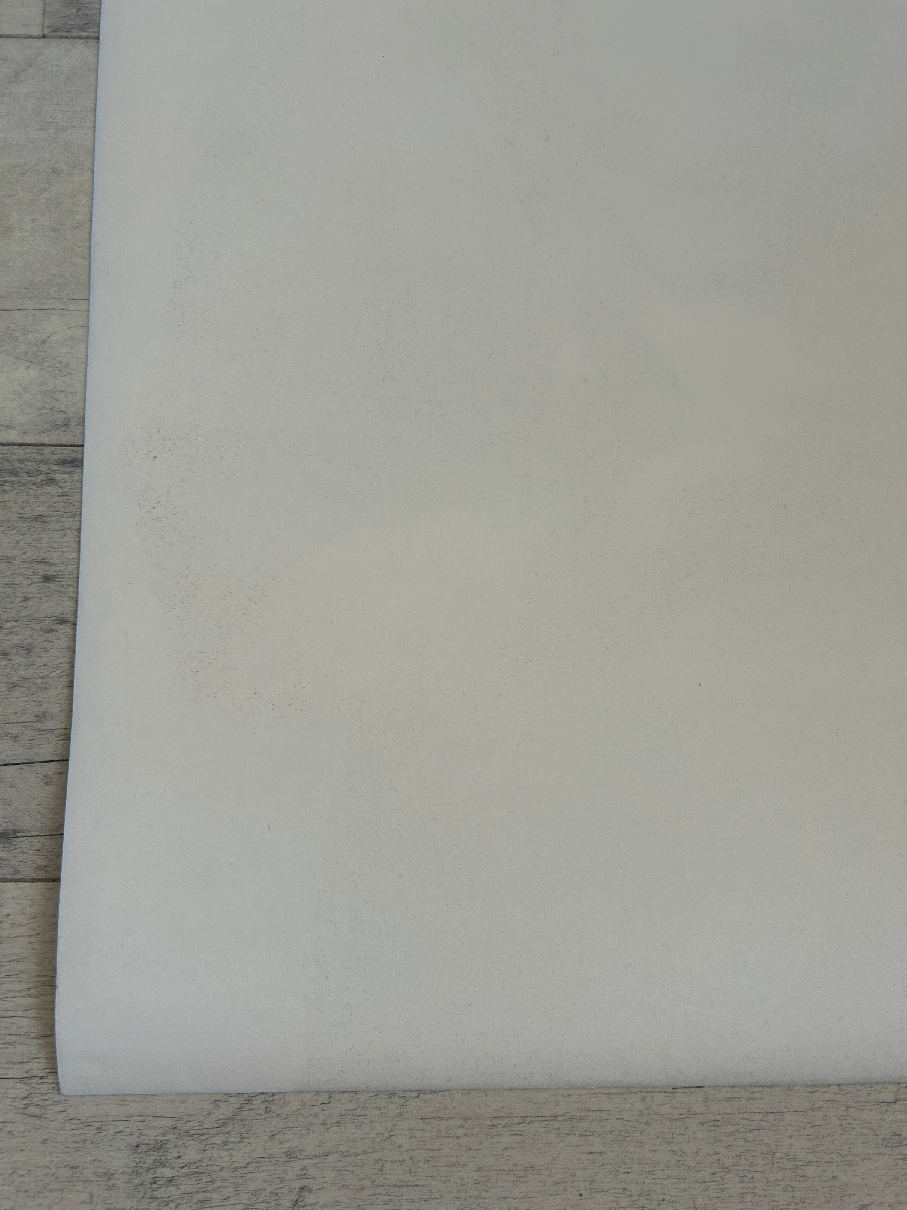 White sheet of paper on a wooden surface